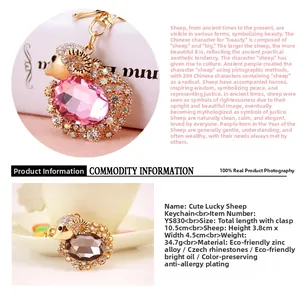 Detail view of pink crystal goat keychain with gold alloy frame and lobster clasp