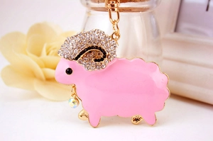 Detailed close-up of pink sheep keychain with rhinestones and gold ring