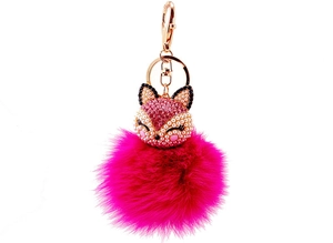 Close-up of rose gold fox keychain with pink pearls and fuchsia faux fur pompom ball