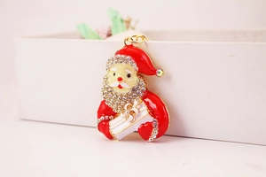 Close-up of Santa Claus keychain with red enamel and sparkling crystal rhinestones