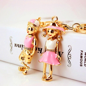 Cute boy and girl couple keychains in gold alloy with pink enamel and crystals