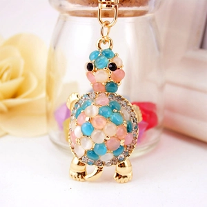 Golden turtle keychain with pink and blue opal stones and sparkling rhinestones