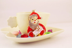 Detailed close-up of sparkling rhinestone Santa Claus pendant with red enamel finish