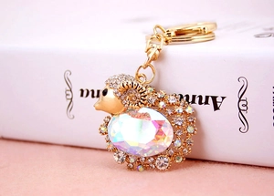 Detailed view of goat keychain with white crystals and large AB iridescent stone