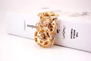 Close-up of golden hollowed-out gourd keychain with traditional Fu character charm
