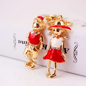 Cute boy and girl couple keychains in gold alloy with red enamel and rhinestones