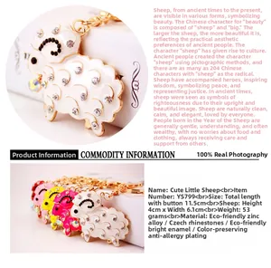 Close-up of cute sheep keychain with sparkling rhinestones and colorful enamel charm