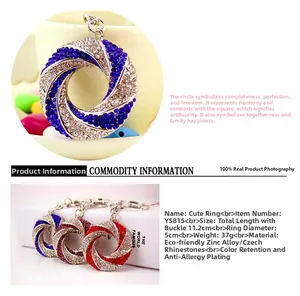 Close-up of sparkling rhinestone-encrusted round metal keychains in blue, red, and purple colors