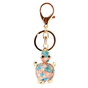 Cute opal tortoise keychain with rhinestones and pink beads on a gold metal frame