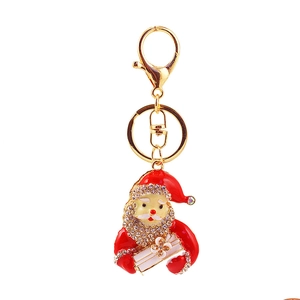 Detailed macro view of rhinestone-encrusted Santa Claus keychain with gold finish