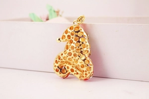 Detailed back view of gold-plated hollow dot pattern pendant with red enamel accents
