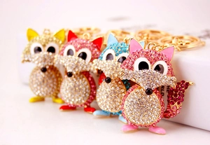 Detailed view of colorful crystal fox keychains in gold, pink, blue and rose gold colors