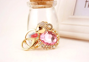 Detail of cute goat keychain with a large pink gemstone and sparkling crystal accents