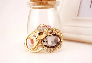 Close-up of golden goat keychain with crystal body and sparkling rhinestones