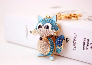 Close-up of sparkling blue and white crystal rhinestones on fox animal keychain