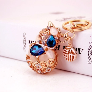 Elegant gold hollow gourd keychain with blue gems and rhinestone details for handbag