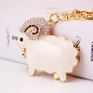 Sparkling rhinestone sheep keychain with gold alloy frame and white enamel body finish