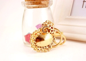 Detailed close-up of golden metal goat keychain with hollowed-out relief and lobster clasp