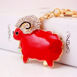 Sparkling crystal sheep keychain with vibrant red enamel and golden metal chain