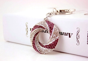 Detail of twisted ring keychain with purple and white rhinestones and lobster clasp