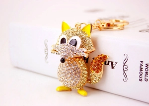 Detailed close-up of a fox keychain featuring gold plating and shimmering crystal rhinestones