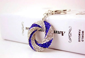 Detailed close-up of blue and white rhinestone encrusted spiral metal keychain