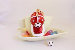 Detail of red and white baseball cap keychain with sparkling rhinestones and football charms