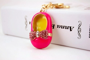 Detailed macro shot of a rose red miniature embroidered shoe keychain with rhinestones
