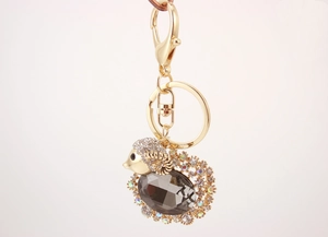 Detailed view of goat keychain featuring a large grey crystal and sparkling rhinestones
