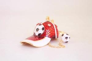 Detail of red and white enamel football cap keychain with rhinestones and mini soccer ball