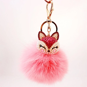 Sparkly pink fox faux fur pompom keychain with golden metal clasp and rhinestones