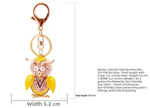 Detailed view of colorful owl keychain with pink rhinestones and yellow enamel wings
