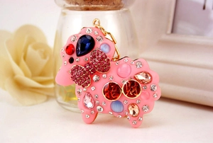 Close-up of sheep keychain with pink resin, blue teardrop stones and rhinestones