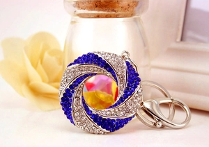 Macro view of blue and white rhinestone circle keychain with lobster clasp detail