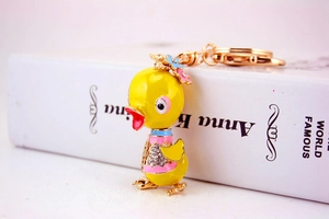 Detailed macro view of yellow duck keychain with sparkling crystals and enamel coating