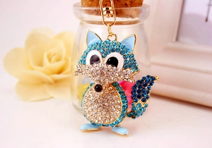Detail of crystal-encrusted blue fox keychain with gold alloy frame and lobster clasp