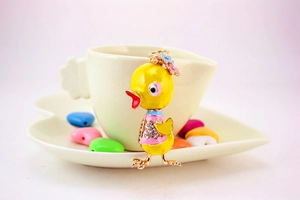 Detail of a yellow duck keychain with enamel flowers and sparkling rhinestones