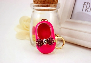 Close-up of pink ballet flat keychain with sparkling crystal bow and golden lobster clasp