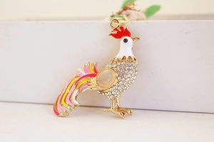 Detailed view of colorful rooster keychain with rhinestones and enamel finish