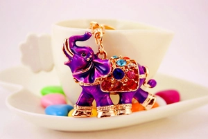 Detail view of purple elephant keychain with colorful rhinestones on a white cup