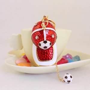 Gold-plated football cap keychain with red enamel, white crystals and soccer ball charms