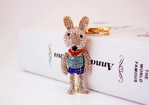 Detailed macro view of rhinestone bunny keychain with blue striped shirt and golden ring