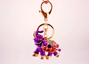 Close-up of purple elephant keychain with colorful rhinestones and gold lobster clasp