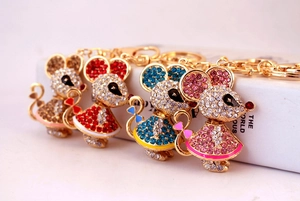 Detailed close-up of four rhinestone mouse keychains in gold, red, blue, and pink finishes