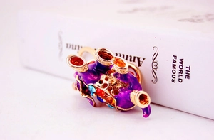 Macro detail of elephant keychain showing purple enamel coating and colorful crystals