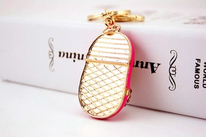Detail view of the gold-tone shoe keychain with rhinestone inlay and non-slip textured sole