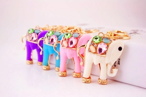 Detail showing colorful elephant pendants with resin gemstones and golden accents