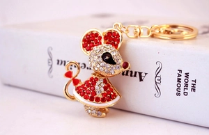 Detailed view of mouse keychain with red and clear rhinestones on golden alloy