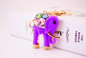 Macro detail of purple elephant keychain with sparkling colored rhinestones and golden accents