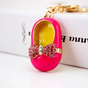 Exquisite rose red baby shoe keychain with golden trim and sparkling rhinestone bow